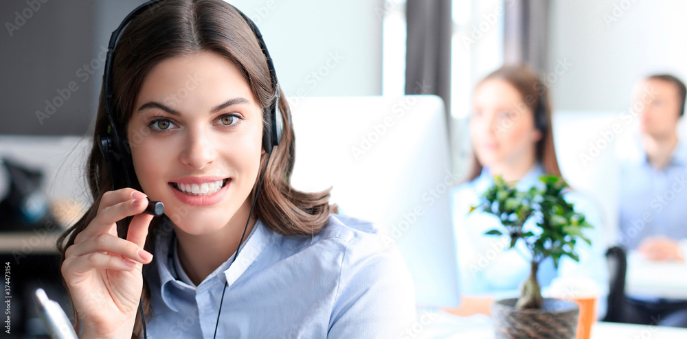 Portrait of call center worker accompanied by his team. Smiling customer support operator at work. Portrait of call center worker accompanied by his team. Smiling customer support operator at work.
