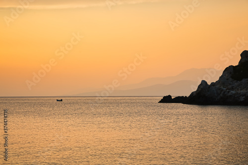 Fisherman Boat on sea during golden sunset, Greece © fazeful