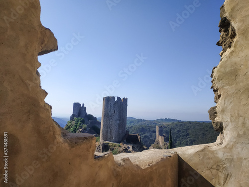 breathtaking view of old castle fortress through opening in the mountains