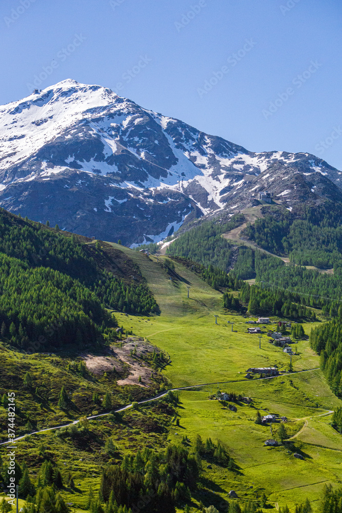 Fototapeta premium The pastures, the mountains and the nature while hiking above the village of Madesimo, Italy - June 2020.