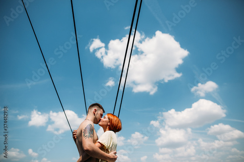 Couple kissing on the roof under the wires