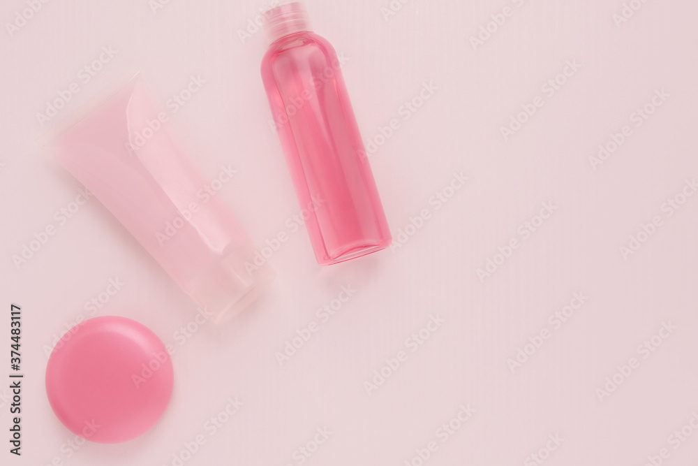 Cosmetics for beauty and skin care, makeup. Cleansing tonic, moisturizing and nourishing cream with collagen and lifting effect, lip balm on a pink background Cosmetics for beauty and skin care, makeup. Cleansing tonic, moisturizing and nourishing cream with collagen and lifting effect, lip balm on a pink background