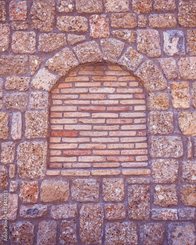 stonewall with arch frame shape and brickwork, textured pattern background