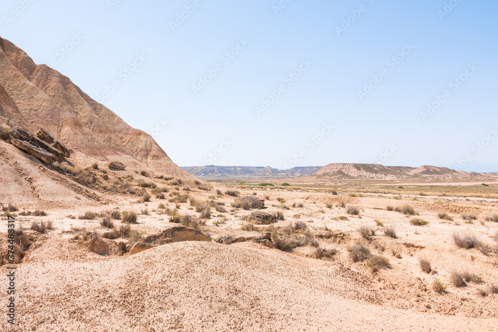 Las Bardenas Reales on a sunny day. Semi-desert natural region, or badlands in southeast Navarre (Spain). Compared to Arizona in the United States of America. No people. Into the wild. Las Bardenas Reales on a sunny day. Semi-desert natural region, or badlands in southeast Navarre (Spain). Compared to Arizona in the United States of America. No people. Into the wild.