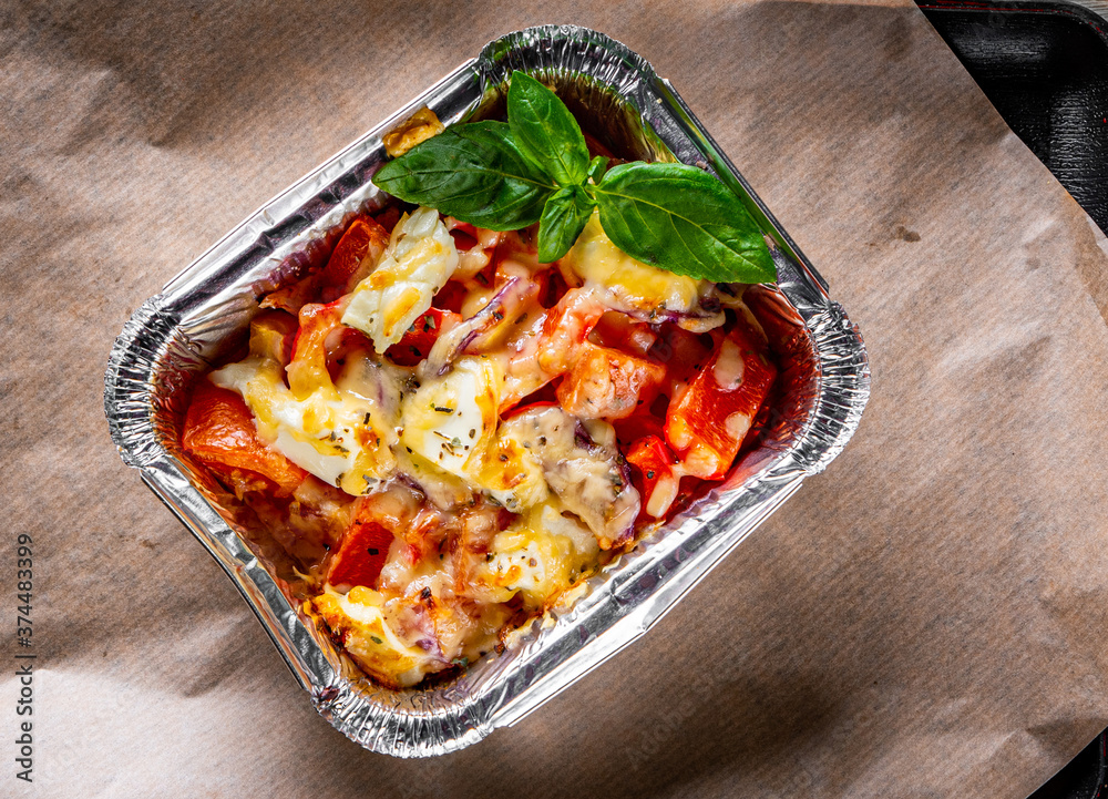 Baked vegetables and feta cheese in a baking dish Baked vegetables and feta cheese in a baking dish