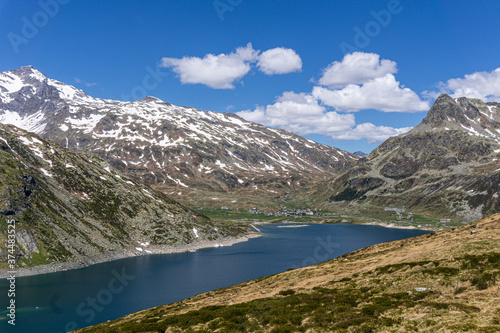 A lake during the summer in the Italian Alps, near the town of Madesimo, Italy - June 2020. photo
