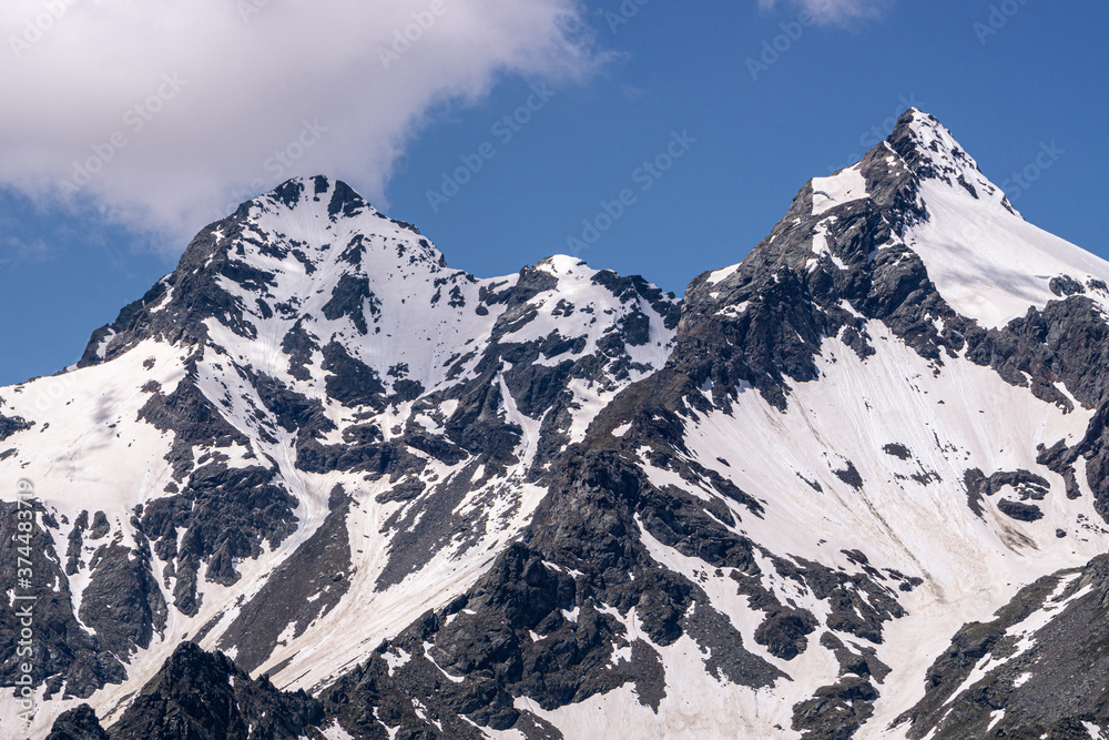 The snow-capped mountains of the Spluga valley during early summer, near the town of Madesimo, Italy - June 2020. The snow-capped mountains of the Spluga valley during early summer, near the town of Madesimo, Italy - June 2020.