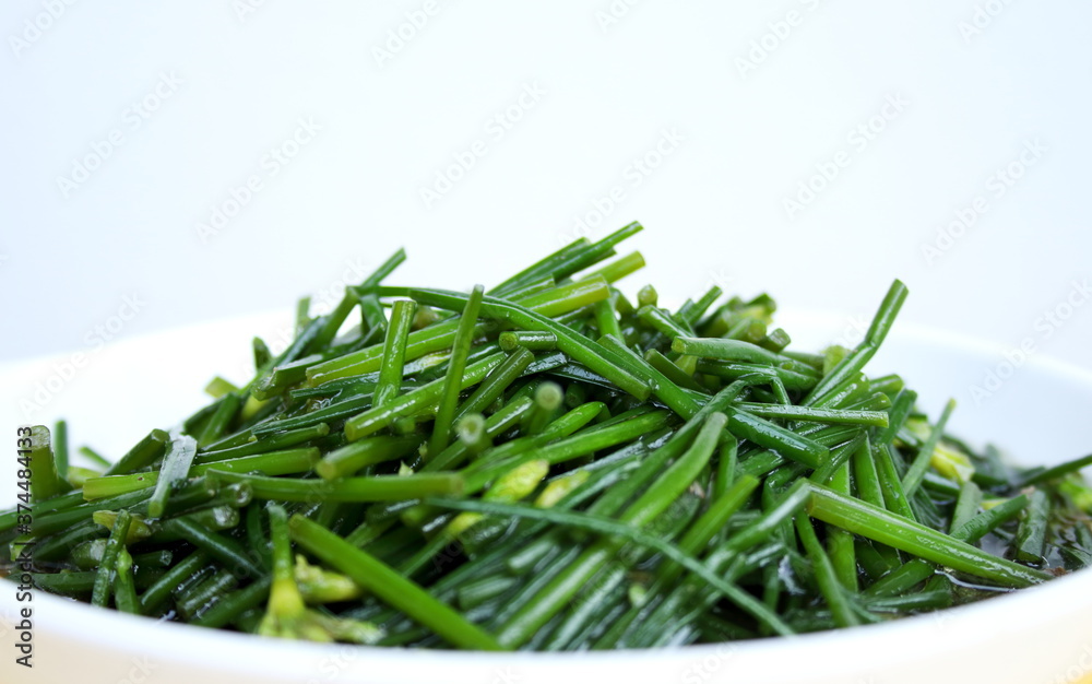 Close up stir fried Chinese chives flowers or Allium tuberosum on white dish. Close up stir fried Chinese chives flowers or Allium tuberosum on white dish.