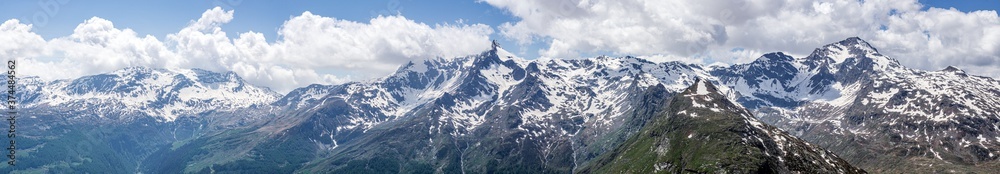 A panoramic view of the mountains and the nature of the spluga valley, near the town of Madesimo, Italy - June 2020.