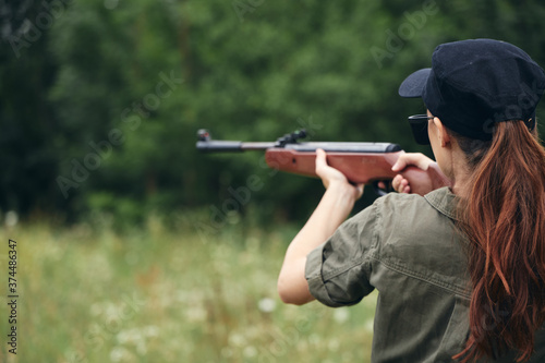 Woman on outdoor weapon in hand sight hunting nature fresh air 
