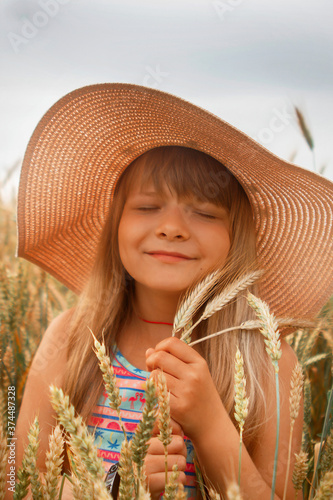 Girl in a hat in a whead field photo