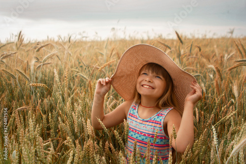Girl in a hat in a whead field