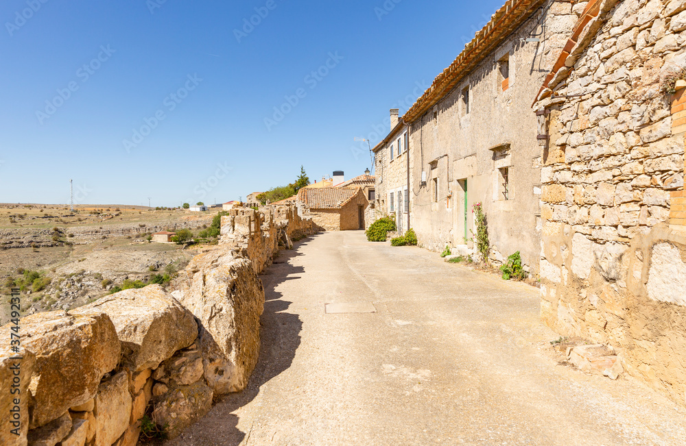 a street with typical old houses and the outside wall in Rello village, province of Soria, Castile and Leon, Spain