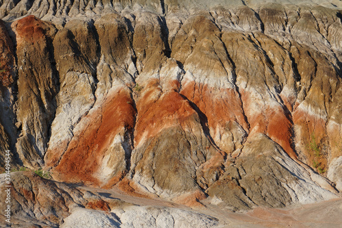 Mountain in a clay quarry. Close-up. A layer of red clay.