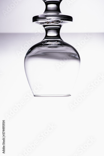 inverted image, one transparent glass cognac glass isolated on white background 