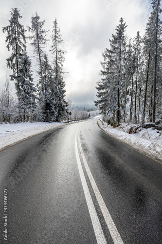 Snowy black asphalt road in Tatra mountains, Poland