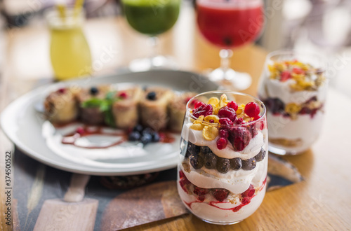 Juice of raspberries and blackberries with citrus and pancakes on the table.