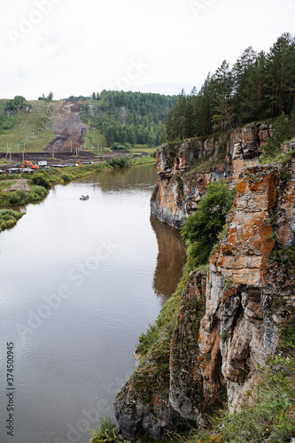 rock mass  river flows at the foot of the rocky mountains  white stone rocks  nature of Russia  southern Urals  Yuryuzan river  travel idea