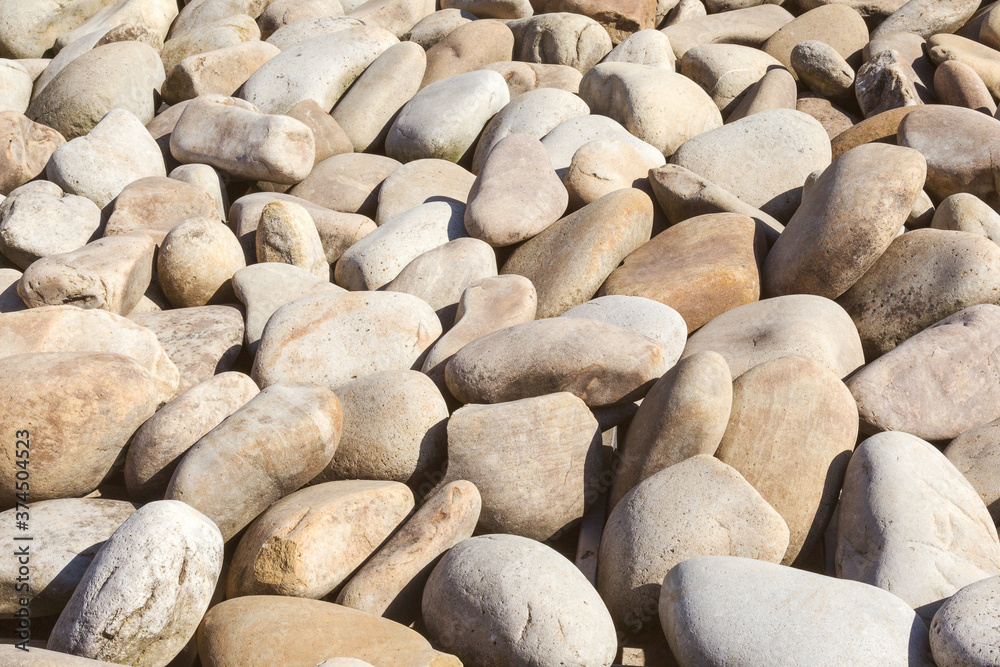 lot of stones close-up on beach, pebbles as textured background