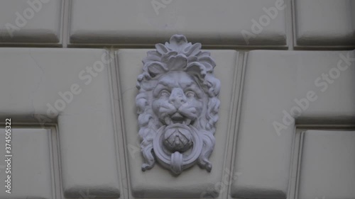 Gipsum lion on the wall of an old house