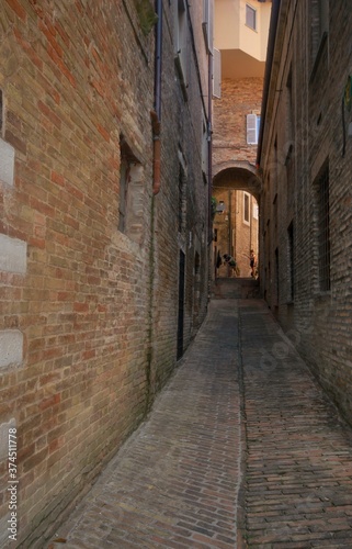 typocal narrow street in old town of urbino, italy