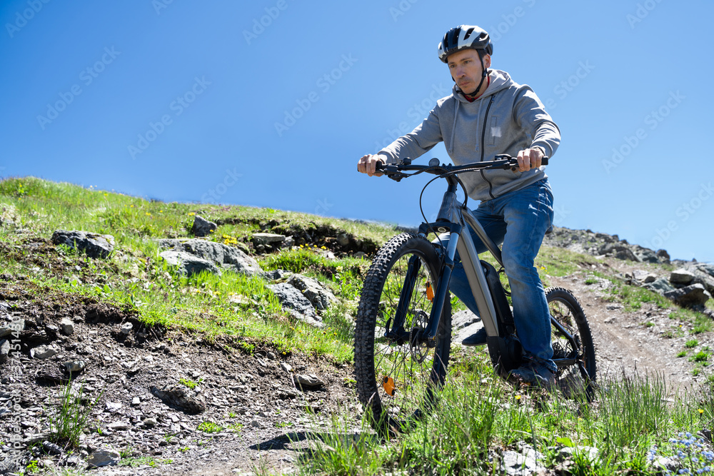 Fototapeta premium Man Riding Electric Mountain Bike