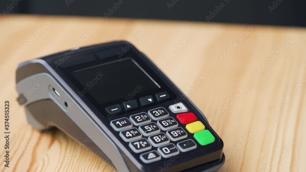 Contactless payment with smartphone with green mock-up screen. Wireless payment concept. Close-up, woman using smartphone cashless wallet NFC technology to pay order on bank terminal. Contactless payment with smartphone with green mock-up screen. Wireless payment concept. Close-up, woman using smartphone cashless wallet NFC technology to pay order on bank terminal.