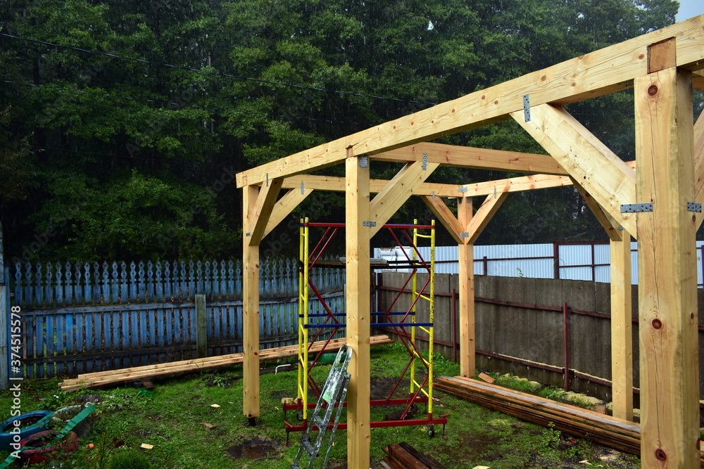 wooden pillars of a large gazebo under construction wooden pillars of a large gazebo under construction