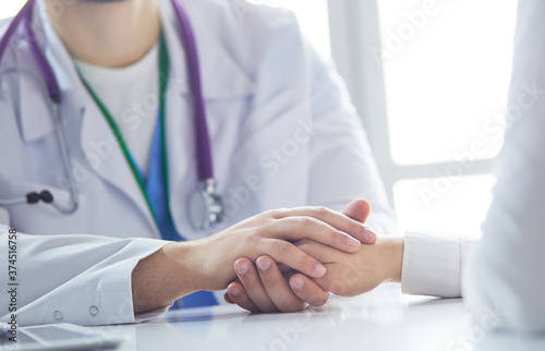 Close-up of stethoscope and paper on background of doctor and patient hands