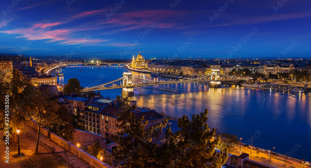 Gorgeous Panoramic cityscape image of Budapest, during sunset. aerial view on Budapest city, Hungarian parliament building and Szechenyi Chain Bridge with streetlight. Hungary.