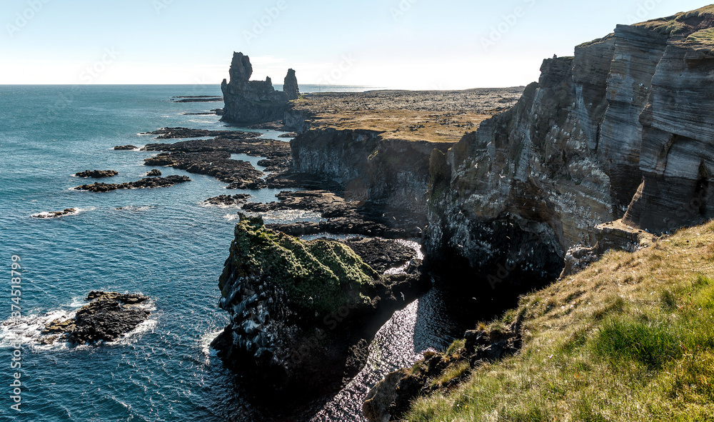 Famous Icelandic view. Londrangar basalt rocks formation on coastline of Snaefellsnes peninsula in western Iceland, Snaefellsnes National Park. Amazing natural background. Picture of wild area