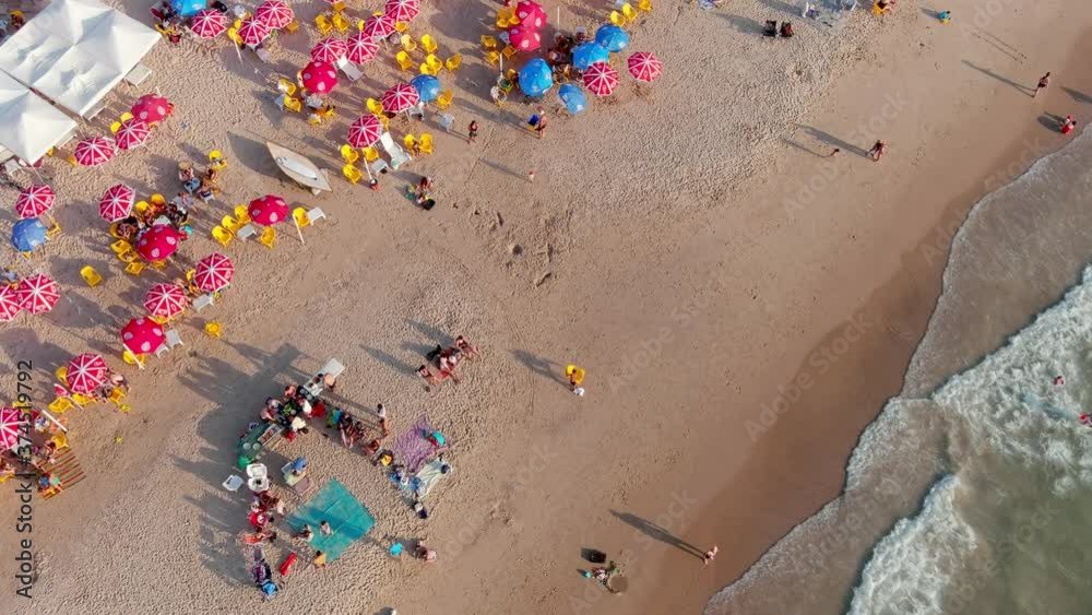 Colourful sea beach on a hot summer day, aerial drone view 4k slow motion Colourful sea beach on a hot summer day, aerial drone view 4k slow motion