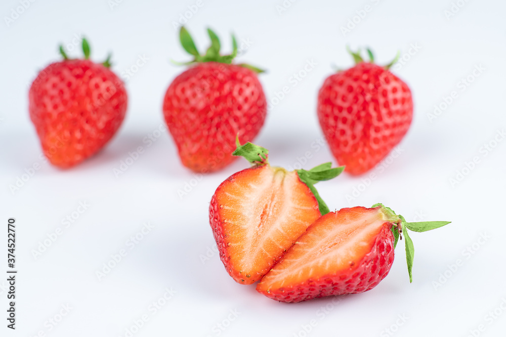 several strawberries are removed from the glare on a white background several strawberries are removed from the glare on a white background