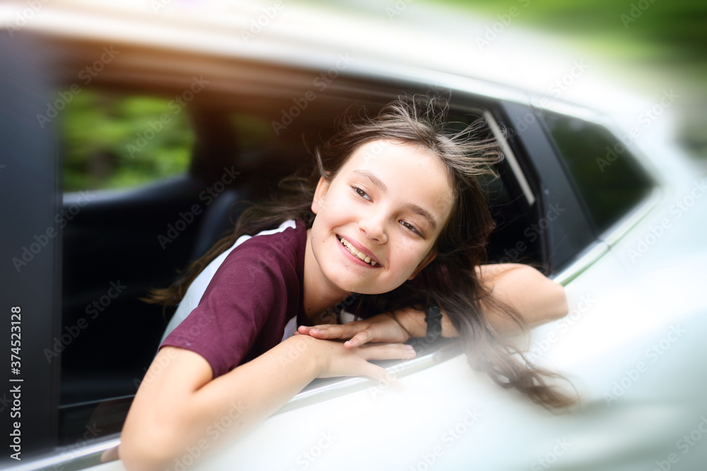 smiling brunette teenage girl is driving the car smiling brunette teenage girl is driving the car