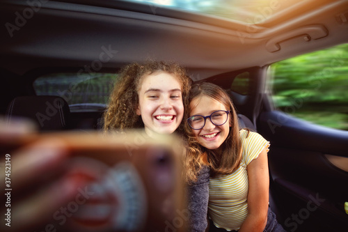 young girls in the car taking a selfie photo of themselves © ambrozinio