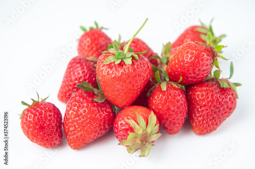 several strawberries are removed from the glare on a white background