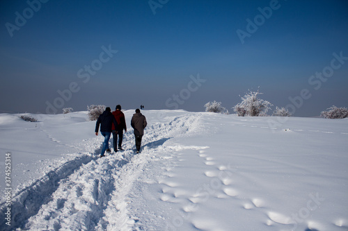 People walking in heavy snow during winter with clear sky in Iasi, Romania