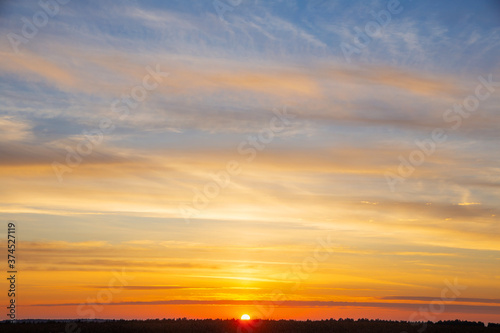 summer evening, sunset in yellow, orange and pink with clouds, background