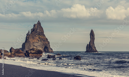 Wonderful view Basalt rock formations Troll toes on black beach in Atlantic ocean. Reynisdrangar, Vik, Iceland. Iceland the country of the best Incredible nature locations.