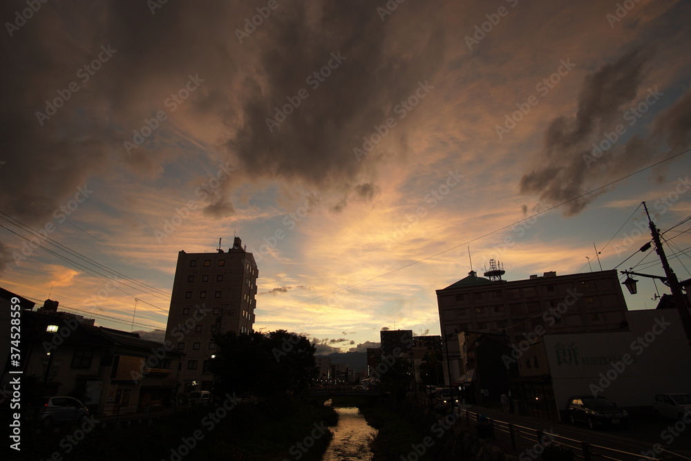sunset scene of small town with street lights in Japan, Matsumoto