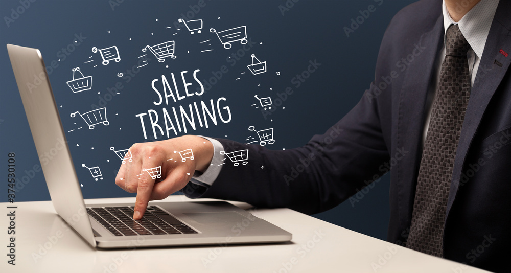 Businessman working on laptop with SALES TRAINING inscription, online shopping concept Businessman working on laptop with SALES TRAINING inscription, online shopping concept