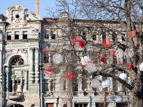 Ancient historical destructible building. Old architecture, broken glass through tree branches with various trinkets photo