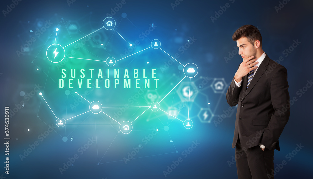 Businessman in front of cloud service icons with SUSTAINABLE DEVELOPMENT inscription, modern technology concept Businessman in front of cloud service icons with SUSTAINABLE DEVELOPMENT inscription, modern technology concept