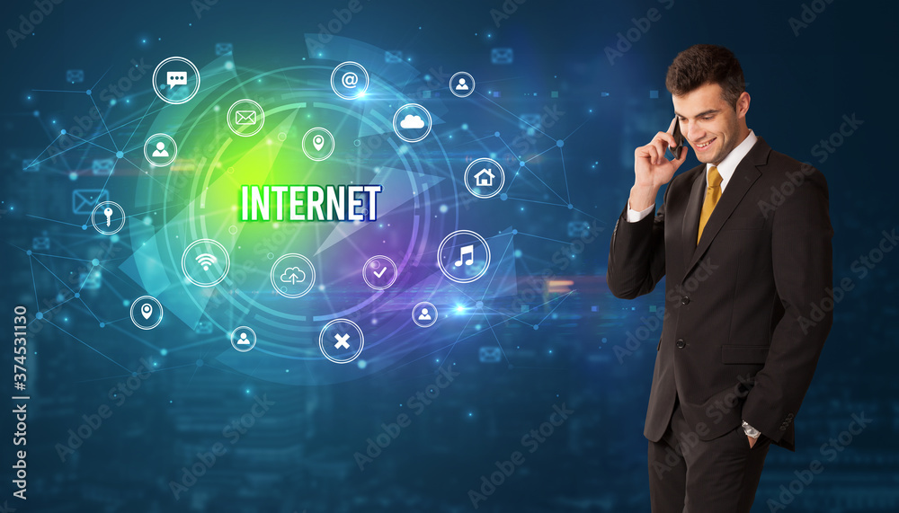 Businessman thinking in front of technology related icons and INTERNET inscription, modern technology concept