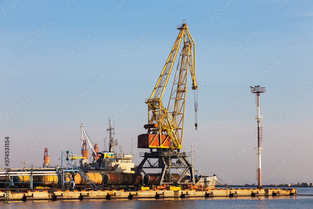 Cargo and transportation industry - cargo shipping and commercial terminal in seaport. Industrial landscape with gantry cranes in sea port.