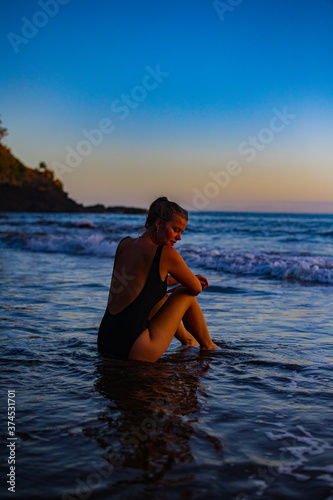 young woman on the beach at sunrise