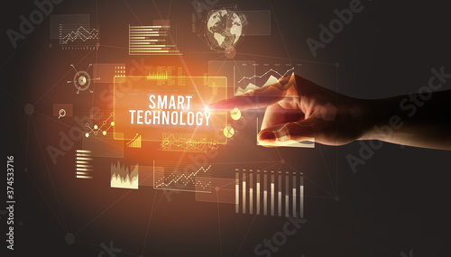 Hand touching SMART TECHNOLOGY inscription, new business technology concept