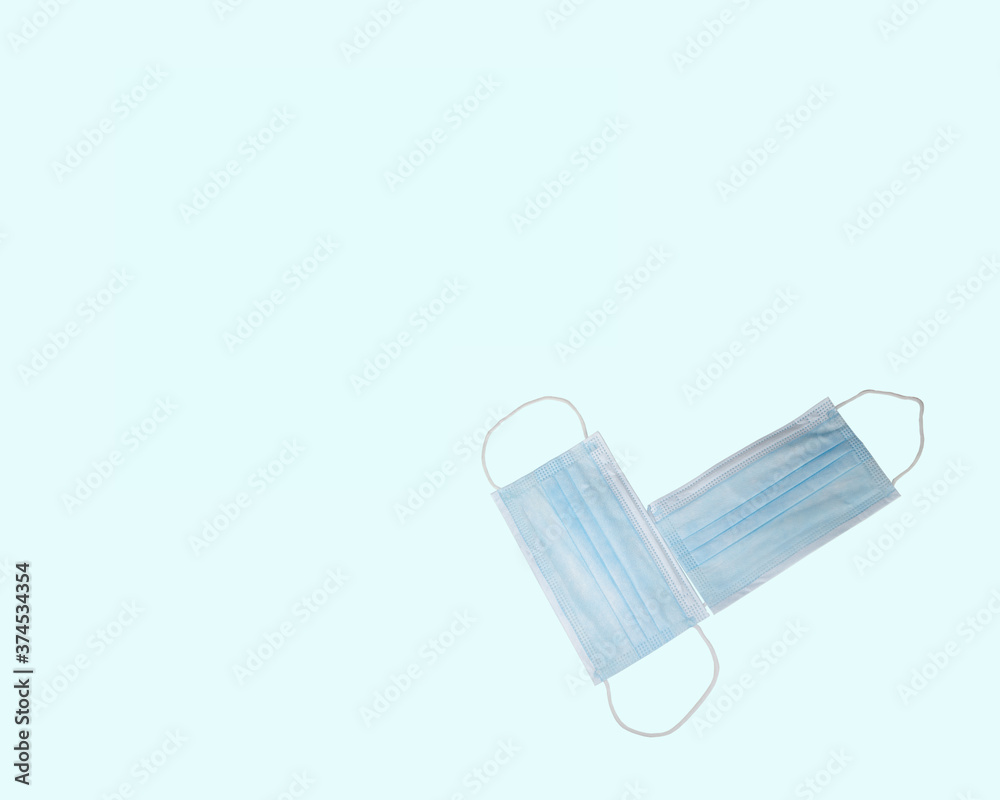 Surgical face masks for preventing allergy, pollution, dust, mold, flu, cold, germ, bacteria and coronavirus (COVID-19) spread - close up, isolated on a blue template background, with copy space Surgical face masks for preventing allergy, pollution, dust, mold, flu, cold, germ, bacteria and coronavirus (COVID-19) spread - close up, isolated on a blue template background, with copy space