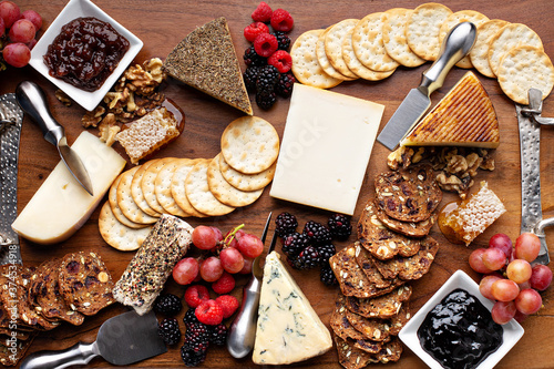 Cheese and snack board with fruit and crackers, cheese variety photo