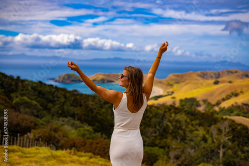 young woman standing on the hill